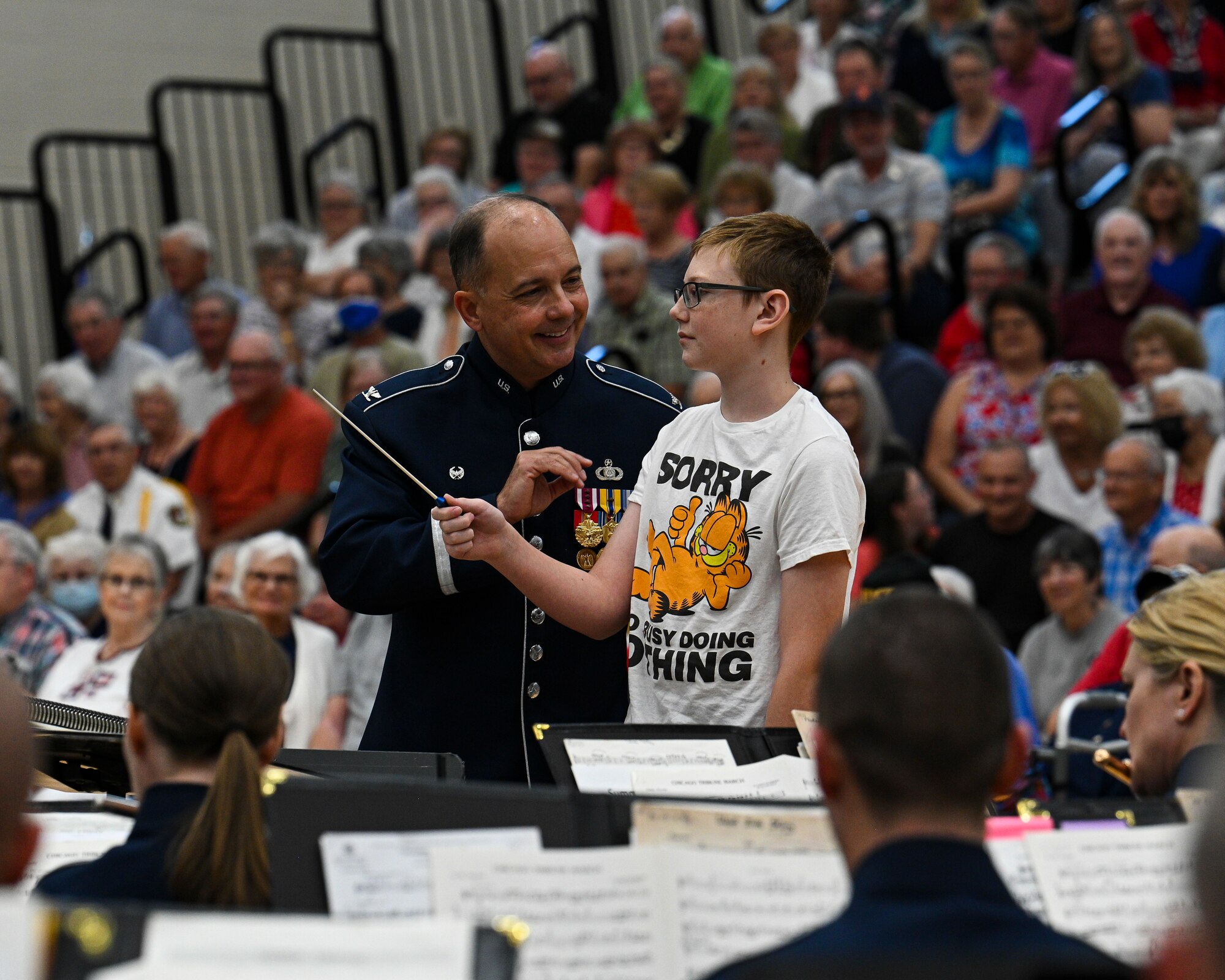 U.S. Air Force Col. Don Schofield, commander and conductor of The United States Air Force Band, teaches a local student how to conduct a band at Paris, Ind., July 3, 2022. The Concert Band performs a wide variety of music ranging from classical transcriptions and original works to solo features, light classics, popular favorites, and patriotic selections. (U.S. Air Force photo by Airman Bill Guilliam)