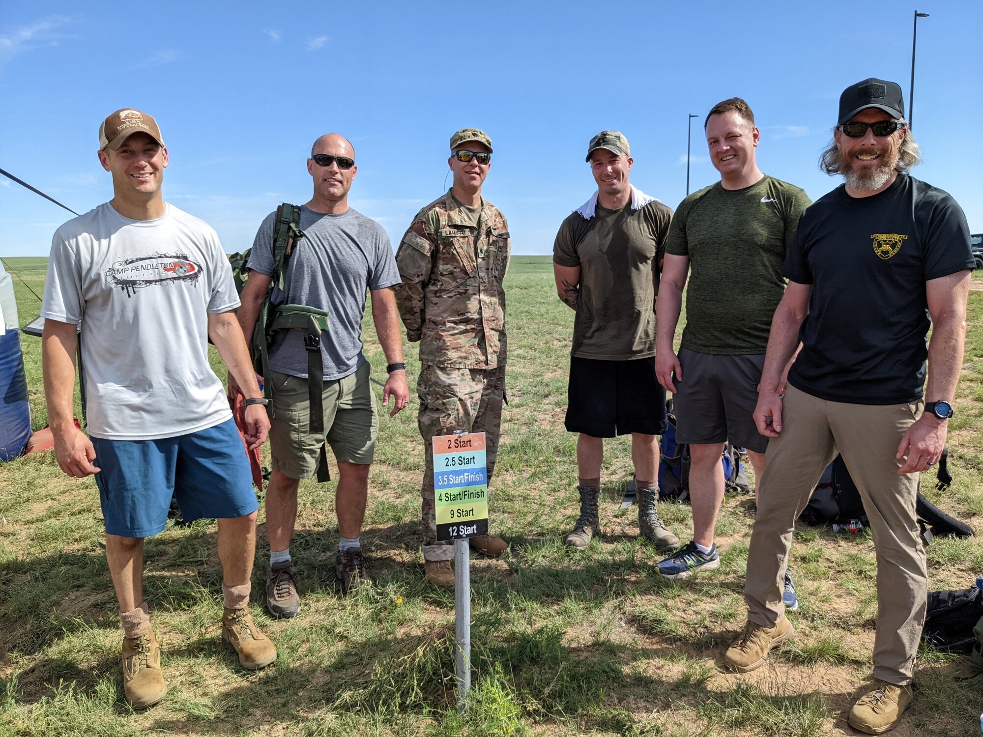 Six men stand and pose for a photo