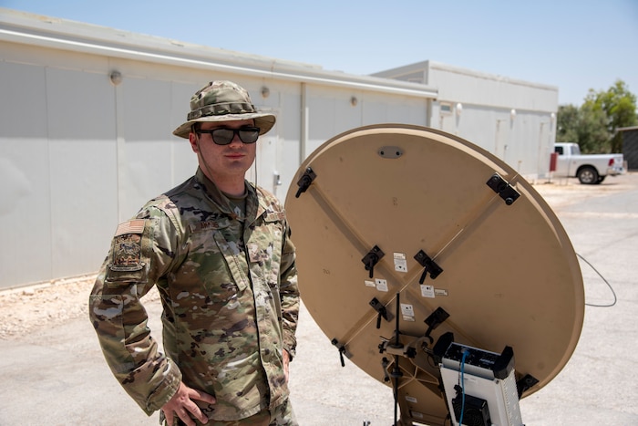 Airman 1st Class Nathan Ammons operates a Communications Fly Away Kit at an undisclosed location, July 20, 2022. The CFK enables the 332d Air Expeditionary Squadron to operate in remote locations by establishing secure communications via satellite. (U.S. Air Force photo by: Tech. Sgt. Jim Bentley)