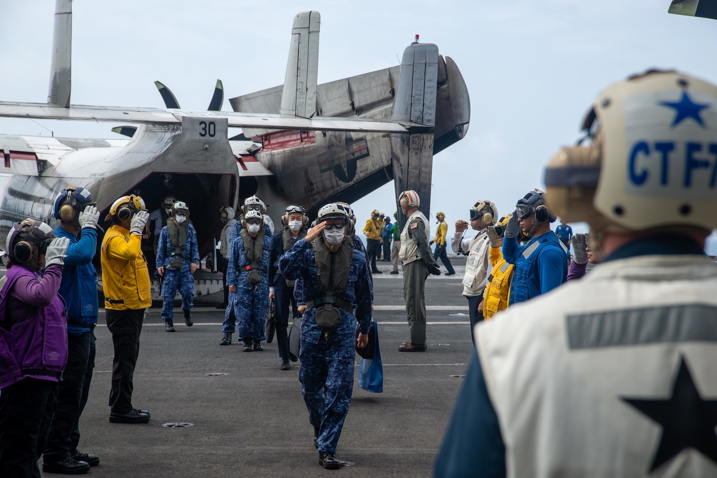 PHILIPPINE SEA (Aug. 5, 2022) Vice Adm. Tatsuya Fukuda, Commander, Fleet Escort Force, Japan Maritime Self-Defense Force, returns a salute to sideboys on the flight deck of the U.S. Navy’s only forward-deployed aircraft carrier USS Ronald Reagan (CVN 76) in the Philippine Sea, Aug. 5. Fukuda and his staff, as well as members of the Japan Ministry of Defense and media personnel, observed flight operations and toured various parts of the ship during their time aboard. Ronald Reagan, the flagship of Carrier Strike Group 5, provides a combat-ready force that protects and defends the United States, and supports alliances, partnerships and collective maritime interests in the Indo-Pacific region. (U.S. Navy photo by Mass Communication Specialist 3rd Class Gray Gibson)