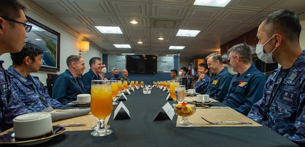 PHILIPPINE SEA (Aug. 5, 2022) Rear Adm. Michael Donnelly, Commander, Task Force (CTF) 70, Vice Adm. Tatsuya Fukuda, Commander, Fleet Escort Force, Japan Maritime Self-Defense Force (JMSDF) and members of CTF 70 and JMSDF, have lunch in the flag mess aboard the U.S. Navy’s only forward-deployed aircraft carrier USS Ronald Reagan (CVN 76) during an embarked tour in the Philippine Sea, Aug. 5. Fukuda and his staff, as well as members of the Japan Ministry of Defense and media personnel, observed flight operations and toured various parts of the ship during their time aboard. Ronald Reagan, the flagship of Carrier Strike Group 5, provides a combat-ready force that protects and defends the United States, and supports alliances, partnerships and collective maritime interests in the Indo-Pacific region. (U.S. Navy photo by Mass Communication Specialist Seaman Natasha ChevalierLosada)
