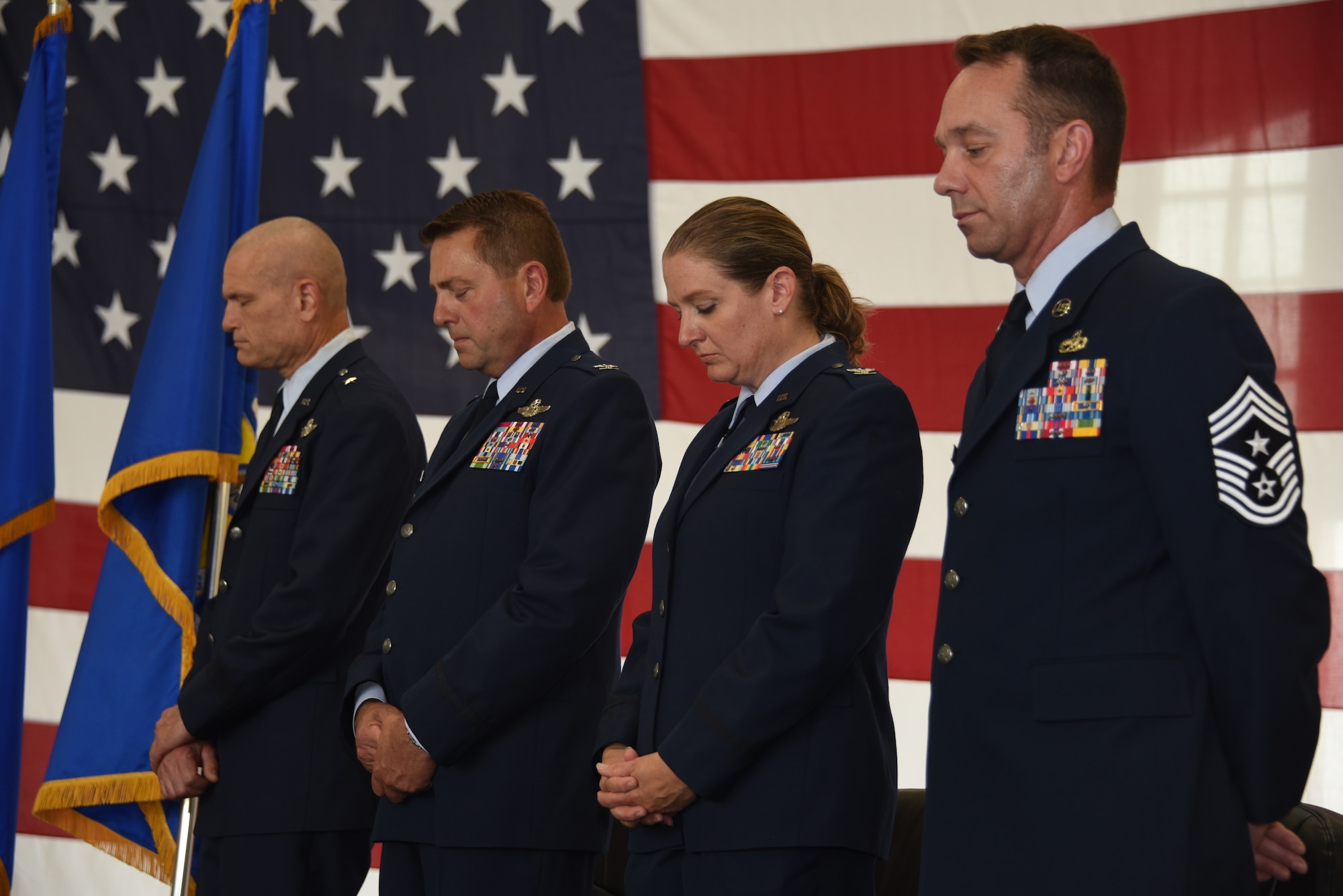 Pictured left to right, Brig. Gen. Shawn Ford, Col. Mark Muckey, Col. Sonya Morrison and Command Chief Ron Lorenzen bow their heads during the invocation prayer