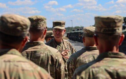 Army Maj. Gen. Robert Burke, the V Corps deputy commanding general for support, talks with Soldiers from the 1st Armored Brigade Combat Team, 3rd Infantry Division at the Army Prepositioned Stocks-2 turn-in site at Grafenwoehr Training Area, Germany, Aug. 3. During his visit, Burke watched members of the 405th Army Field Support Brigade and the 1st ABCT conduct joint preventative maintenance checks and services, and he met with 1st ABCT Soldiers to discuss the turn-in process and hear their experiences. (Photo by Maj. Patrick Connelly)