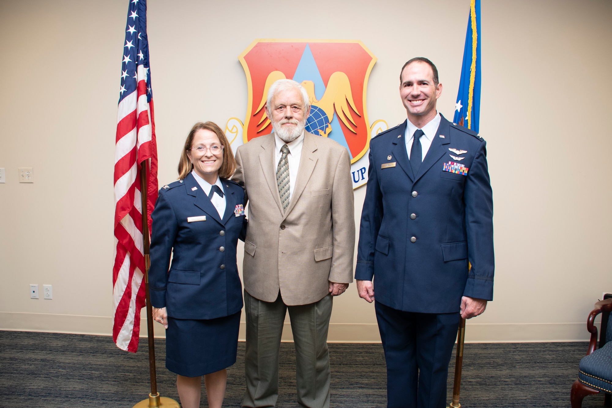 Col. Christopher Spinelli, 932nd Medical Group commander, (right), Col. Jennifer Brothers, incoming 932nd Aeromedical Staging Squadron, (left), and Brothers father (middle), pose for a photo following the ASTS assumption of command, Aug 7, 2022, Scott Air Force Base, Ill. (U.S. Air Force photo by SSgt Brooke Spenner)