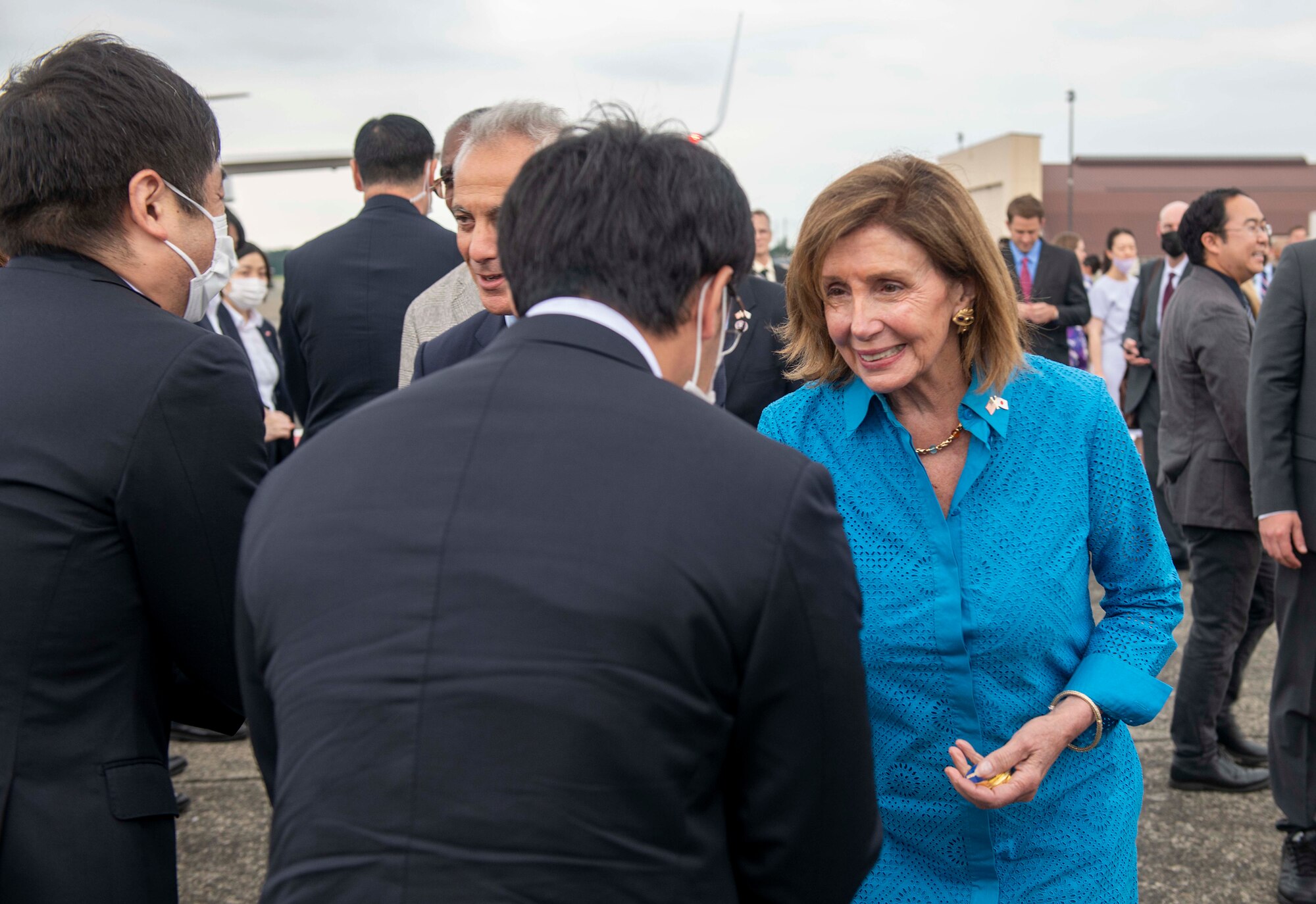 Speaker of the House Nancy Pelosi interacts with a Japanese official