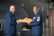 Chief Master Sgt. Gary L. Spaulding, right, military personnel management officer for the Kentucky Air National Guard, receives a plaque from  Maj. Gen. Charles M. Walker, director of the Office of Complex Investigations at the National Guard Bureau, during Spaulding’s retirement ceremony at the Kentucky Air National Guard Base in Louisville, Ky., June 12, 2022. Spaulding served 35 in the Kentucky Air Guard. (U.S. Air National Guard photo by Phil Speck)