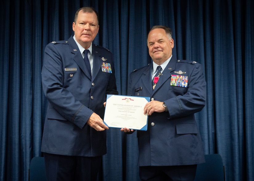 Col. Robert Hamm, left, former commander of the 123rd Operations Group, presents Col. David Lalonde, director of Air operations at Joint Forces Headquarters—Kentucky, with the Legion of Merit during Lalonde’s retirement ceremony, held May 14, 2022 at the Kentucky Air National Guard base in Louisville, Ky. (U.S. Air National Guard photo by Staff Sgt. Clayton Wear)