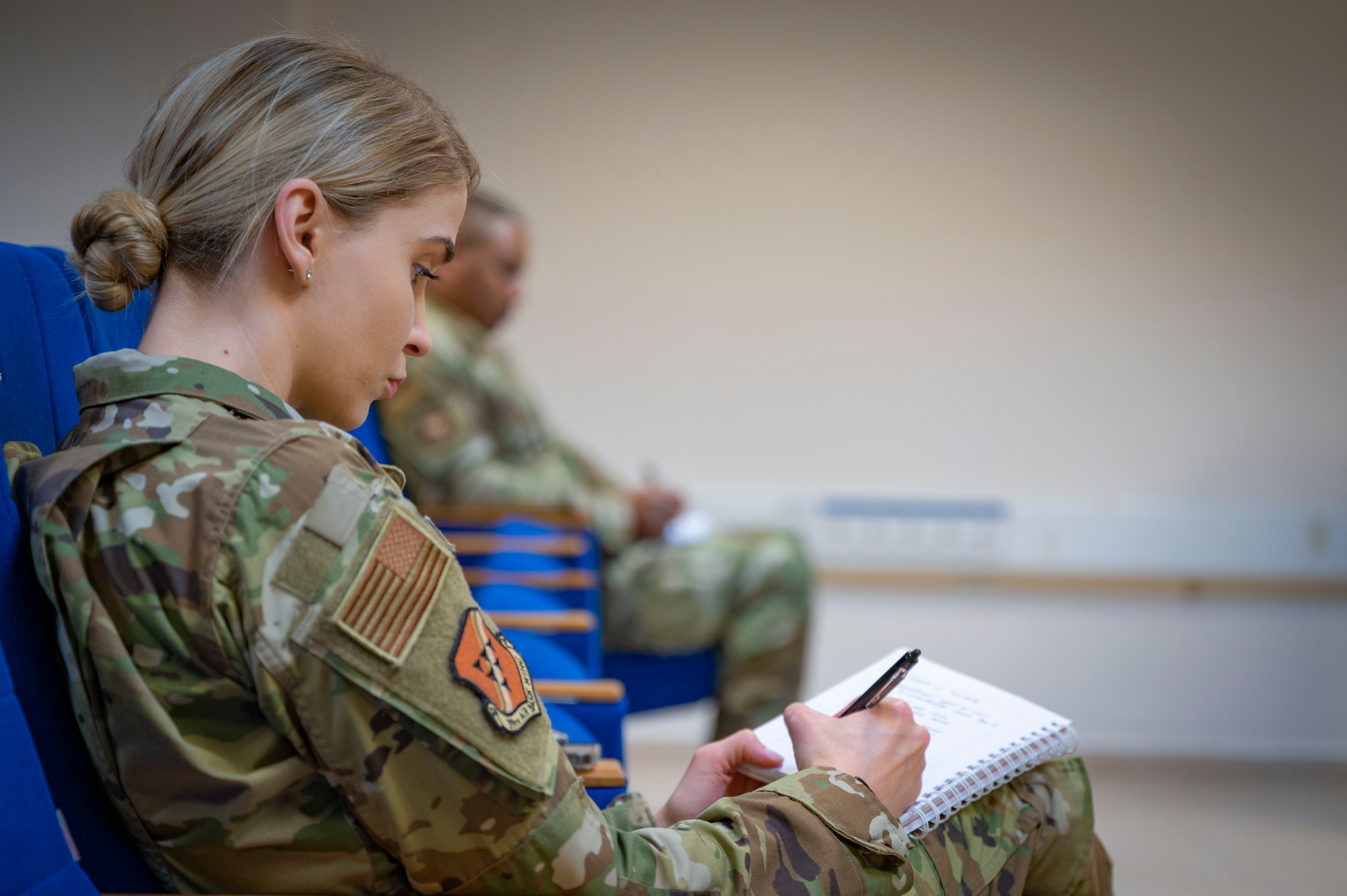 Tech. Sgt. Flavia Carver, noncommissioned officer in charge of Equal Opportunity assigned to the 39th Air Base Wing, notes key information during the First Sergeant symposium at Incirlik Air Base, Turkey, August 1, 2022. The symposium is held twice a year focusing on preparing technical sergeants and master sergeants with the skills needed to serve as interim first sergeants. The purpose of this event is teach additional duty first sergeants what it means to fill the role and share knowledge with those who might be interested in wearing a diamond of their own one day. (U.S. Air Force photo by Staff Sgt. Gabrielle Winn)