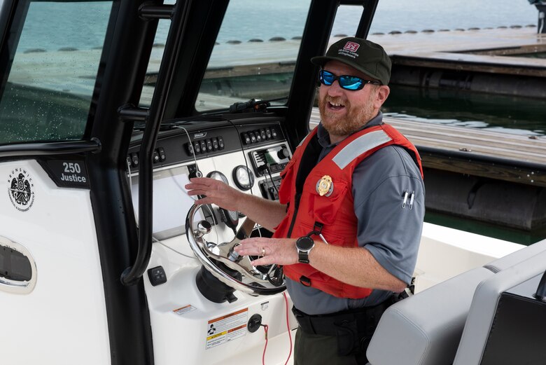 Resource Manager Jonathan Friedman stands at the controls of the lake staff’s new patrol boat on Lake Cumberland at Marina at Rowena in Albany, Kentucky, Aug. 5, 2022. (USACE Photo by Lee Roberts)