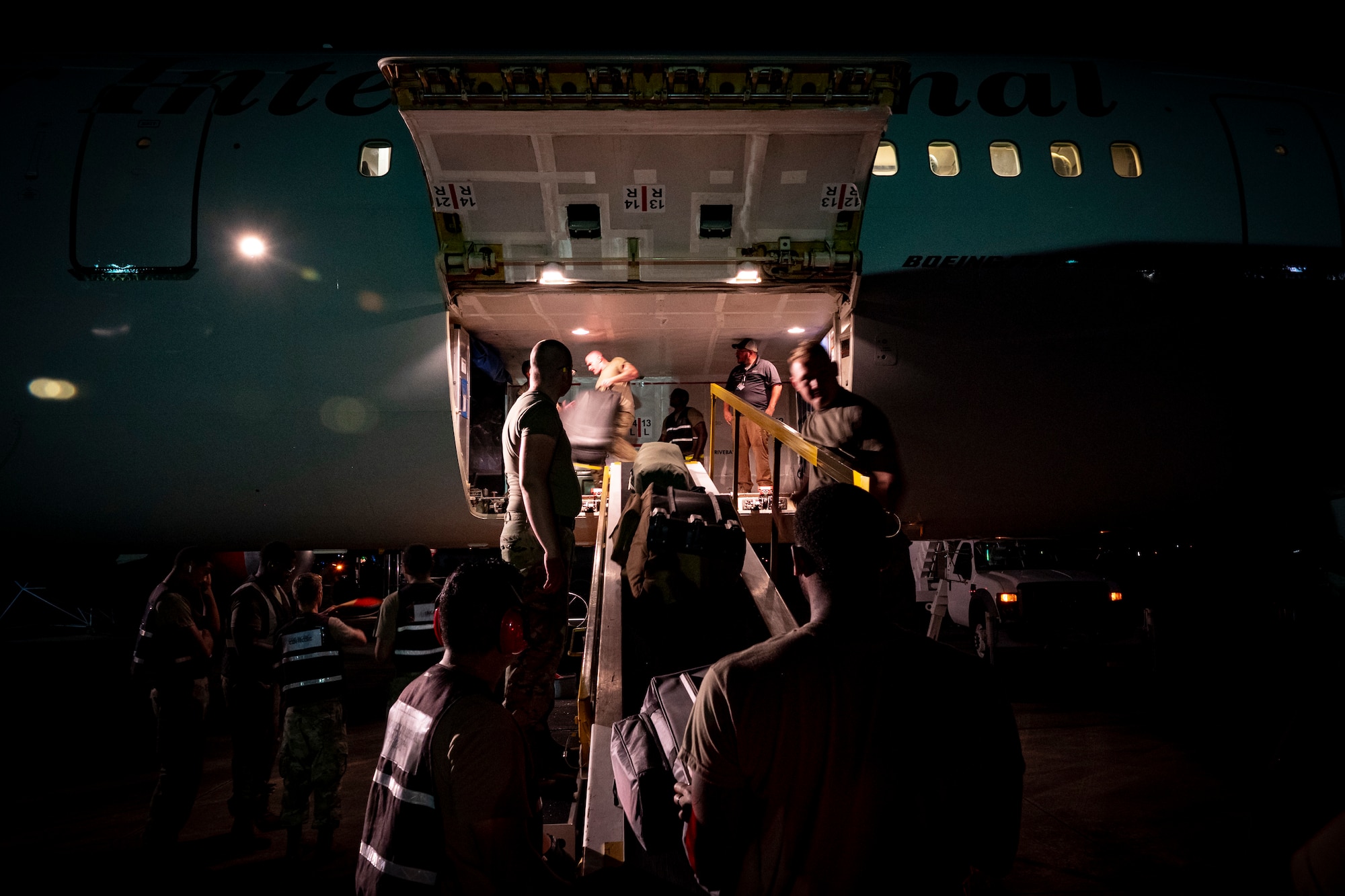 Shaw AFB Airmen load luggage onto an aircraft