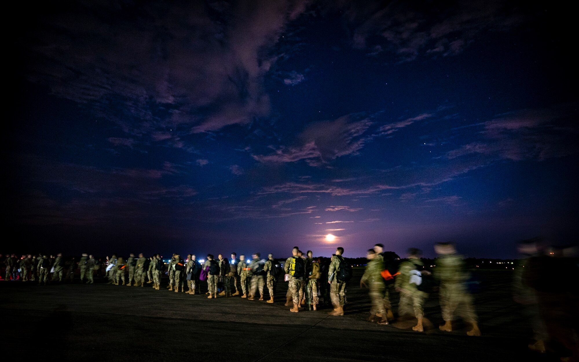 Shaw AFB Airmen step to a commercial aircraft before deployment