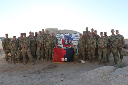 Command Group from the Independence Brigade pose for photo at “Painted Rocks,” with their newly painted 56 SBCT rock featuring the Liberty Bell along with the name of each participating Task Force.