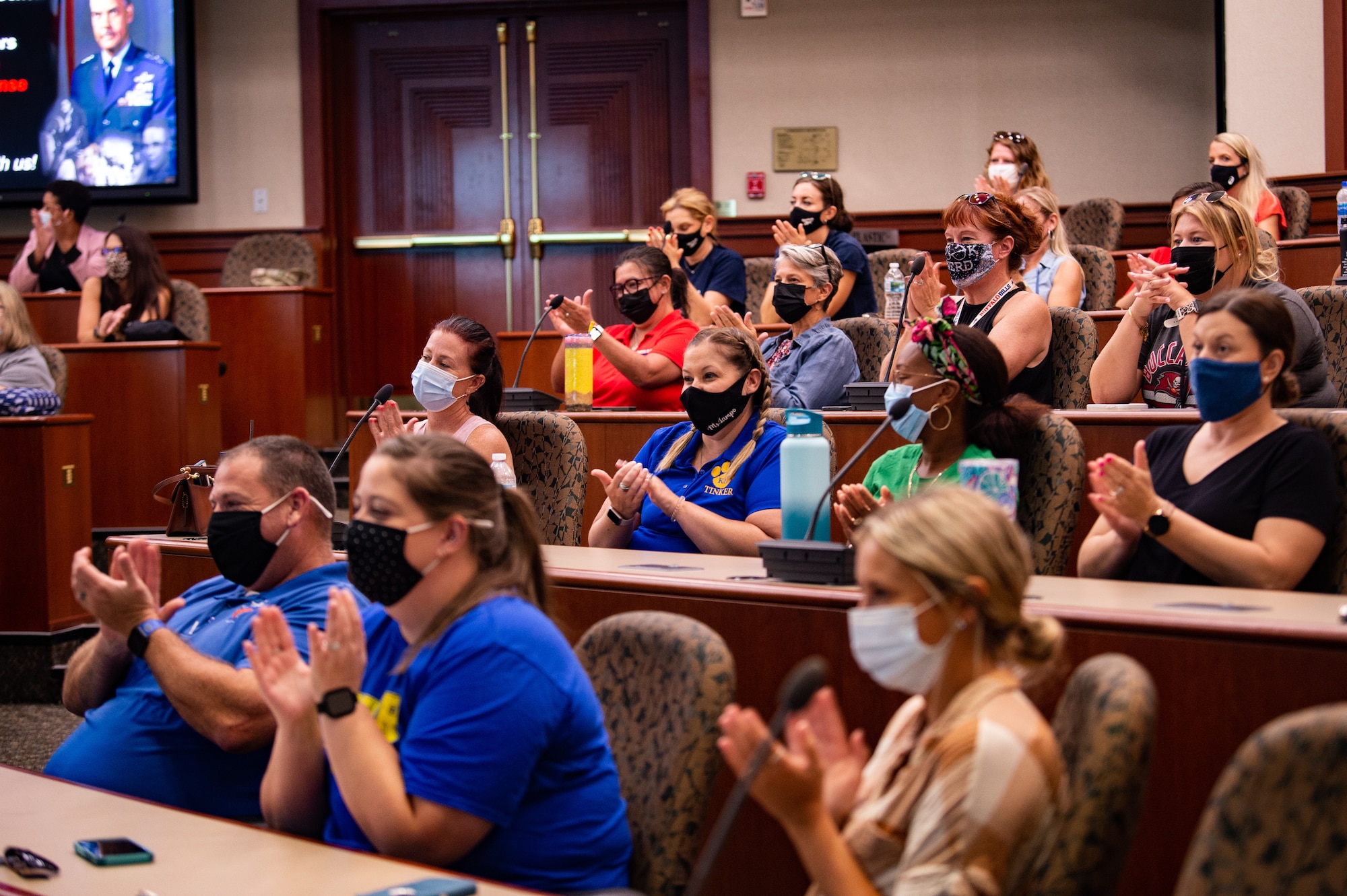 A group of teachers from Hillsborough County Schools clap for a mental health presentation during an immersion tour at MacDill Air Force Base, Florida, Aug 4, 2022. The tour gave teachers a better understanding of the unique struggles that military dependents face. (U.S. Air Force photo by Airman 1st Class Michael Killian)