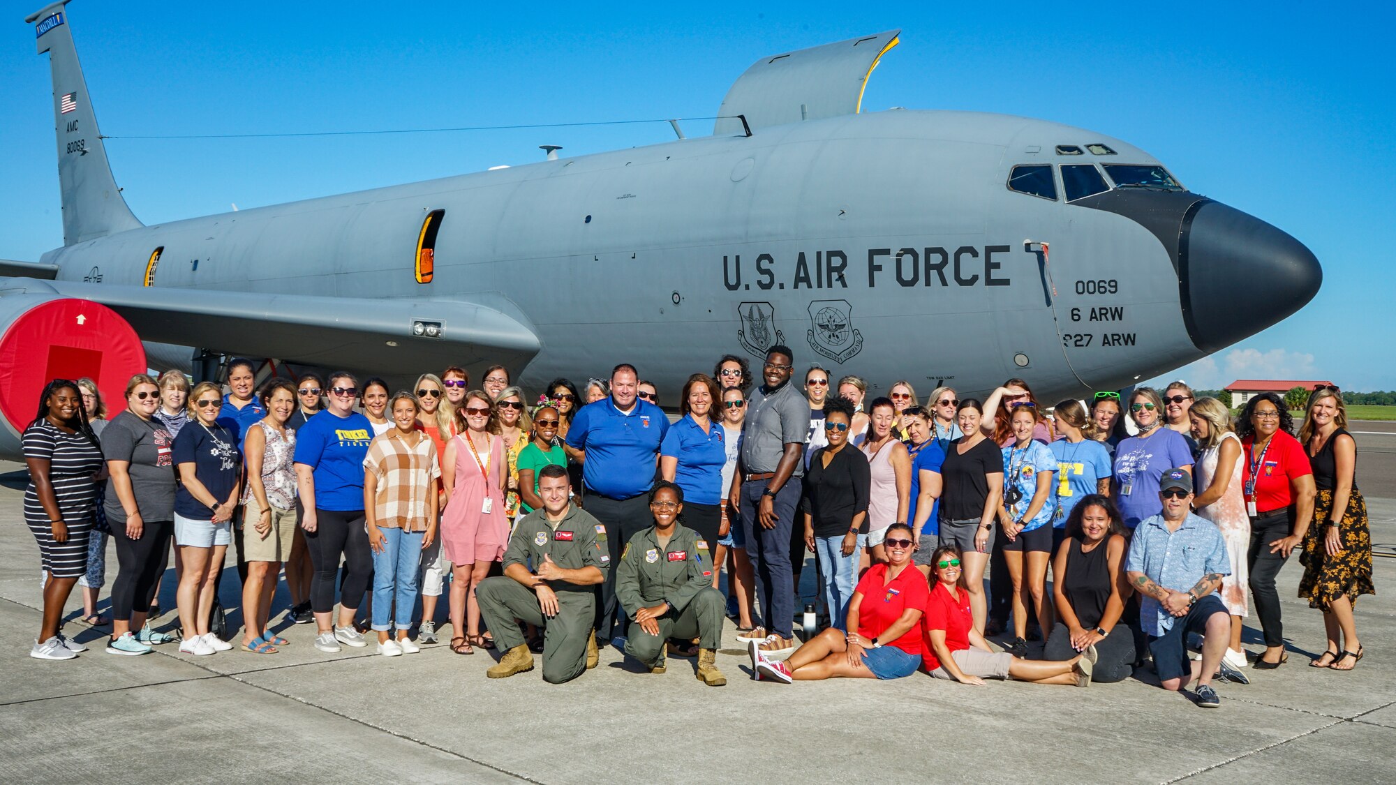A group of teachers from Hillsborough County Schools pose for a group photo during a teacher immersion tour at MacDill Air Force Base, Florida, Aug 4, 2022. The primary goal of the tour was to help teachers gain more insight into topics such as child psychology, MacDill’s mission and mental health among military children.  (U.S. Air Force photo by Airman 1st Class Michael Killian)