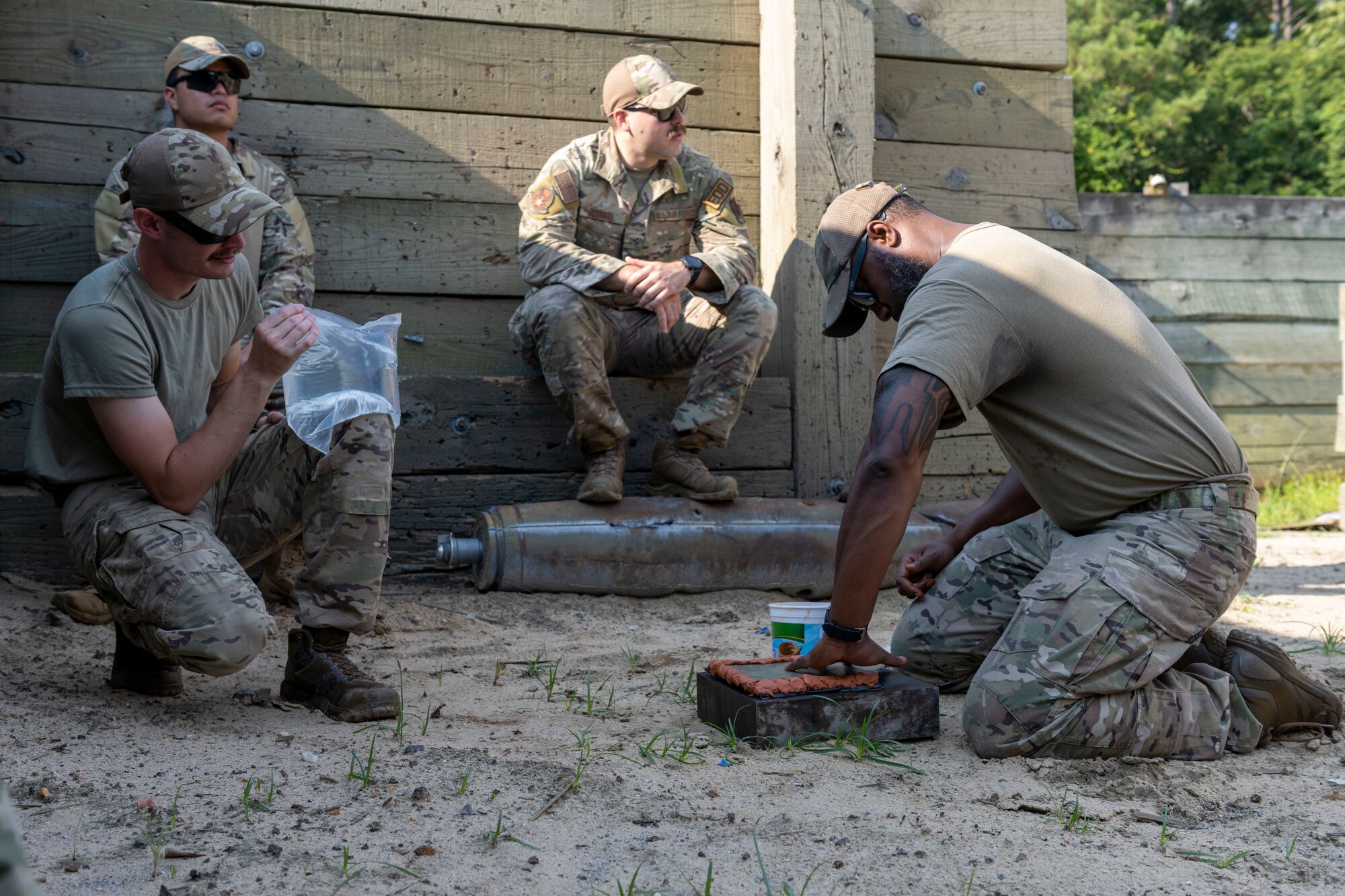 Airmen assigned to the 4th Civil Engineer Squadron’s Explosive Ordnance Disposal flight, prepare a controlled detonation at Seymour Johnson Air Force Base, North Carolina, Aug. 4, 2022. The detonations helped refine the Airmen’s skills that are needed for deployment. (U.S. Air Force photo by Senior Airman Kevin Holloway)