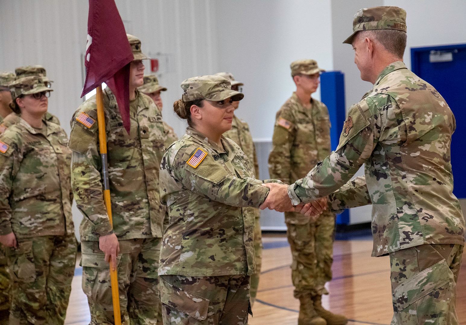 Maj. Gen. Rich Neely, the Adjutant General of Illinois and Commander of the Illinois National Guard, shakes hands with Maj. Karen Hernandez, of Bensenville, Commander, 709th Medical Company Area Support, based in Bartonville, after the deployment ceremony Aug. 6 at Monroe Elementary School in Peoria, Illinois.