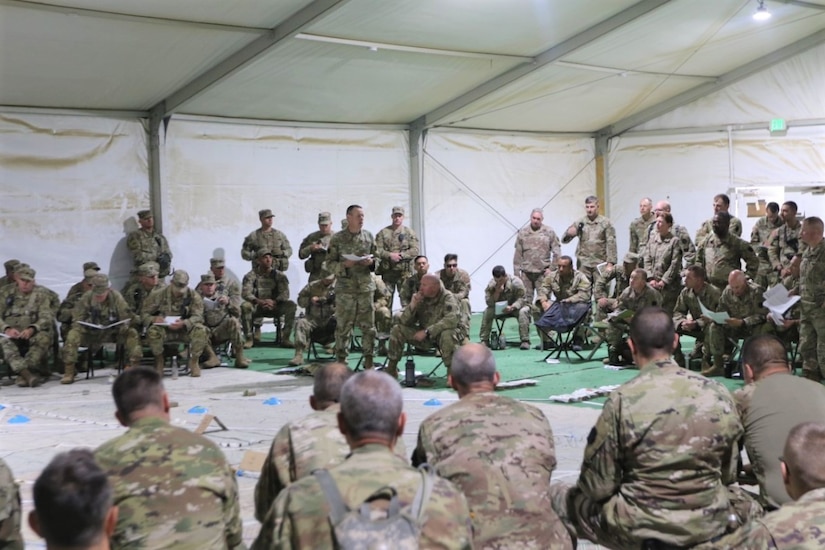 Col. Jon Farr, commander of the 56th Stryker Brigade Combat Team, addresses key leadership, staff and observer/coach/trainers during a Combined Arms Rehearsal, during the brigade's recent rotation at the National Training Center at Fort Irwin, Calif.