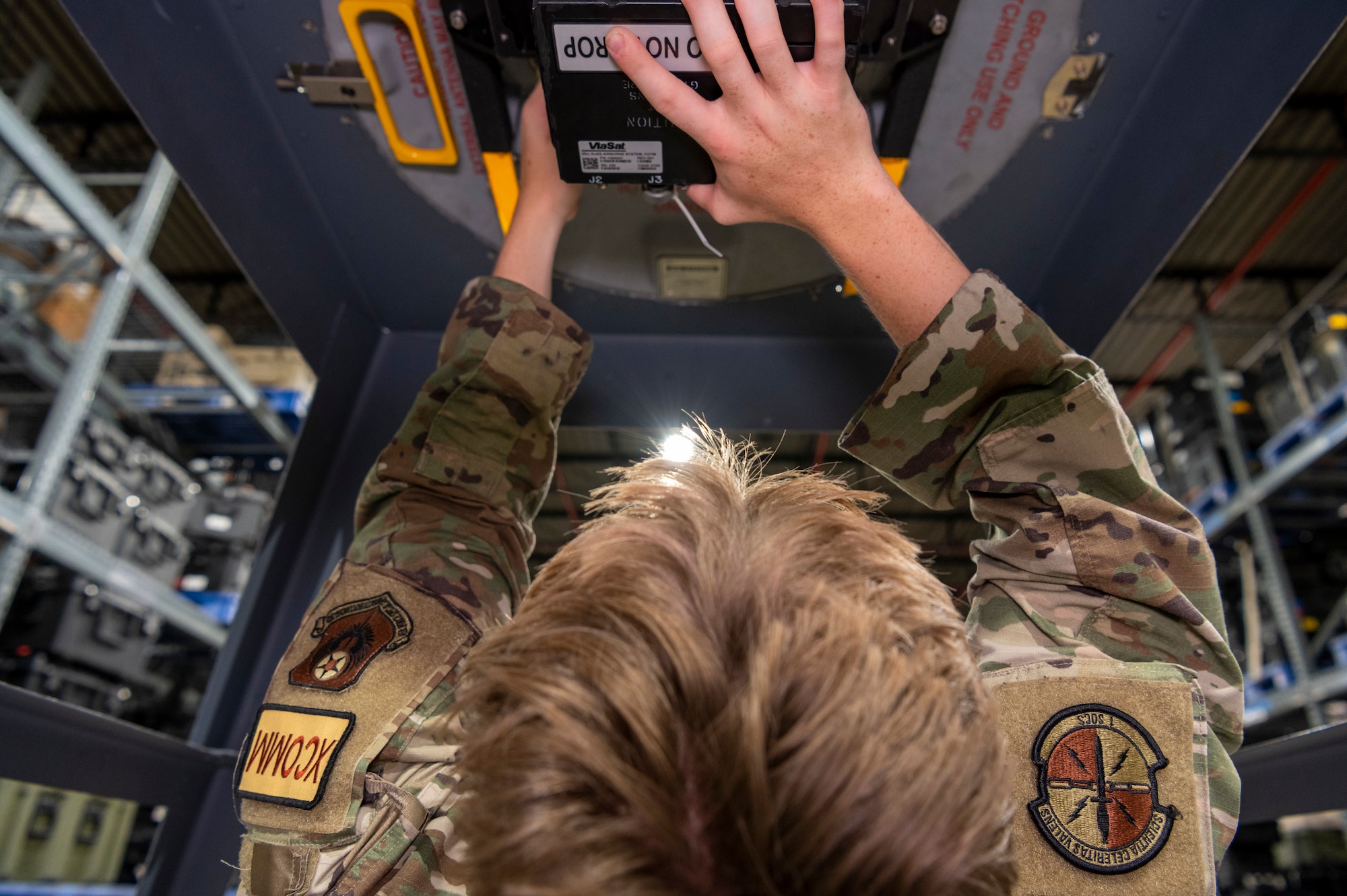 U.S. Air Force Senior Airman Lucas Gross, an Airborne Mission Network technician assigned to the 1st Special Operations Communications Squadron, attaches an Inertial Reference Unit (IRU) to the bottom side of an antenna that is then later attached to an In-Vehicle-Equipment or IVE-Kit, Aug. 4, 2022 at Hurlburt Field, Florida. The IRU and IVE-Kit equipment allow training to be conducted in a classroom setting without the need to step out to work on an aircraft.