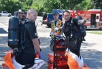 Members of the Wisconsin National Guard’s 54th Civil Support Team (CST) identify where they will enter a building with a notional contaminant as part of a hazardous material training exercise in Poynette, Wis., July 14 at the Village Hall.