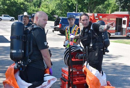 Members of the Wisconsin National Guard’s 54th Civil Support Team (CST) identify where they will enter a building with a notional contaminant as part of a hazardous material training exercise in Poynette, Wis., July 14 at the Village Hall.