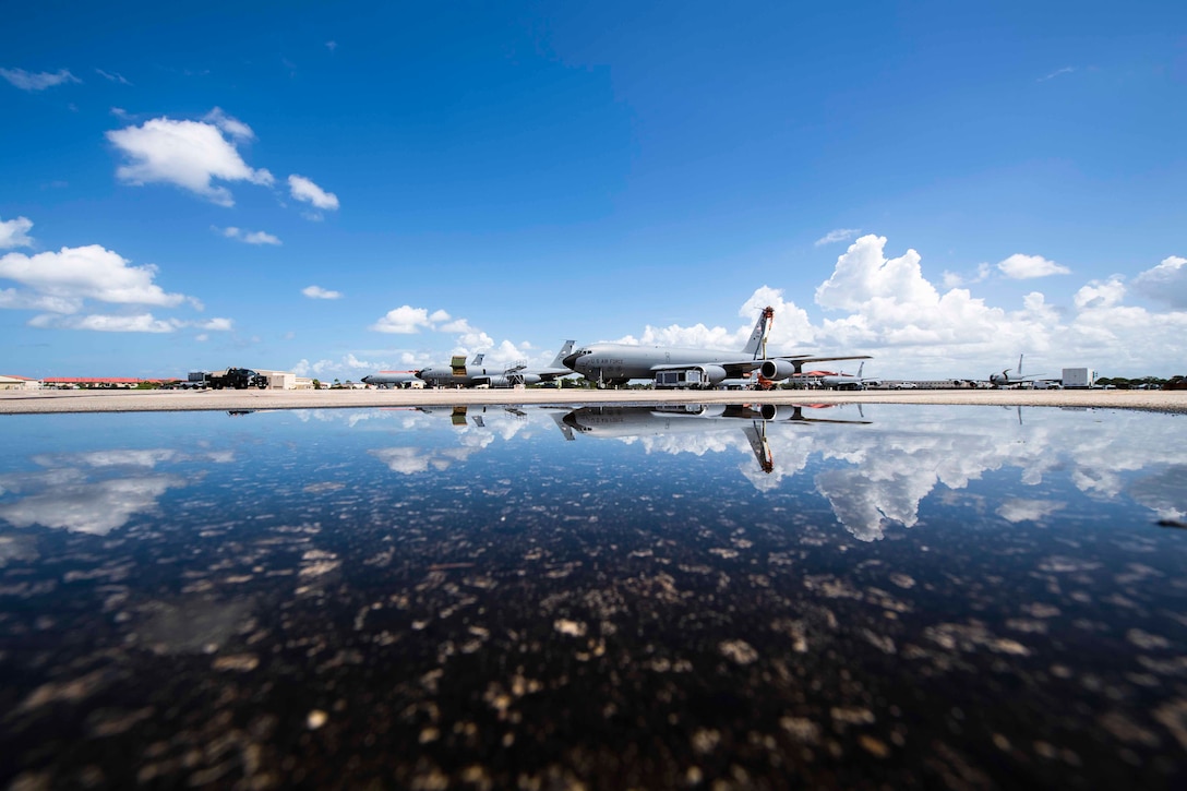 Water shows the reflection of aircraft parked.