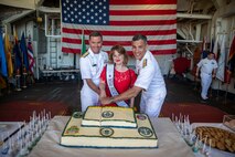 Rear Adm. Mark Sucato, left, Shellie Hart, middle, and Rear Adm. Carlos Sardiello cut a cake at the U.S. Navy reception held aboard Ticonderoga-class guided missile cruiser USS Lake Champlain (CG 57) during Fleet Week Seattle, Aug. 6, 2022.Fleet Week Seattle is a time-honored celebration of the sea services and provides an opportunity for the citizens of Washington to meet Sailors, Marines and Coast Guardsmen, as well as witness firsthand the latest capabilities of today's maritime services. (U.S. Navy Photo by Mass Communication Specialist 2nd Class Ethan J. Soto)