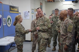 Gen. Michael E. Kurilla shakes hand