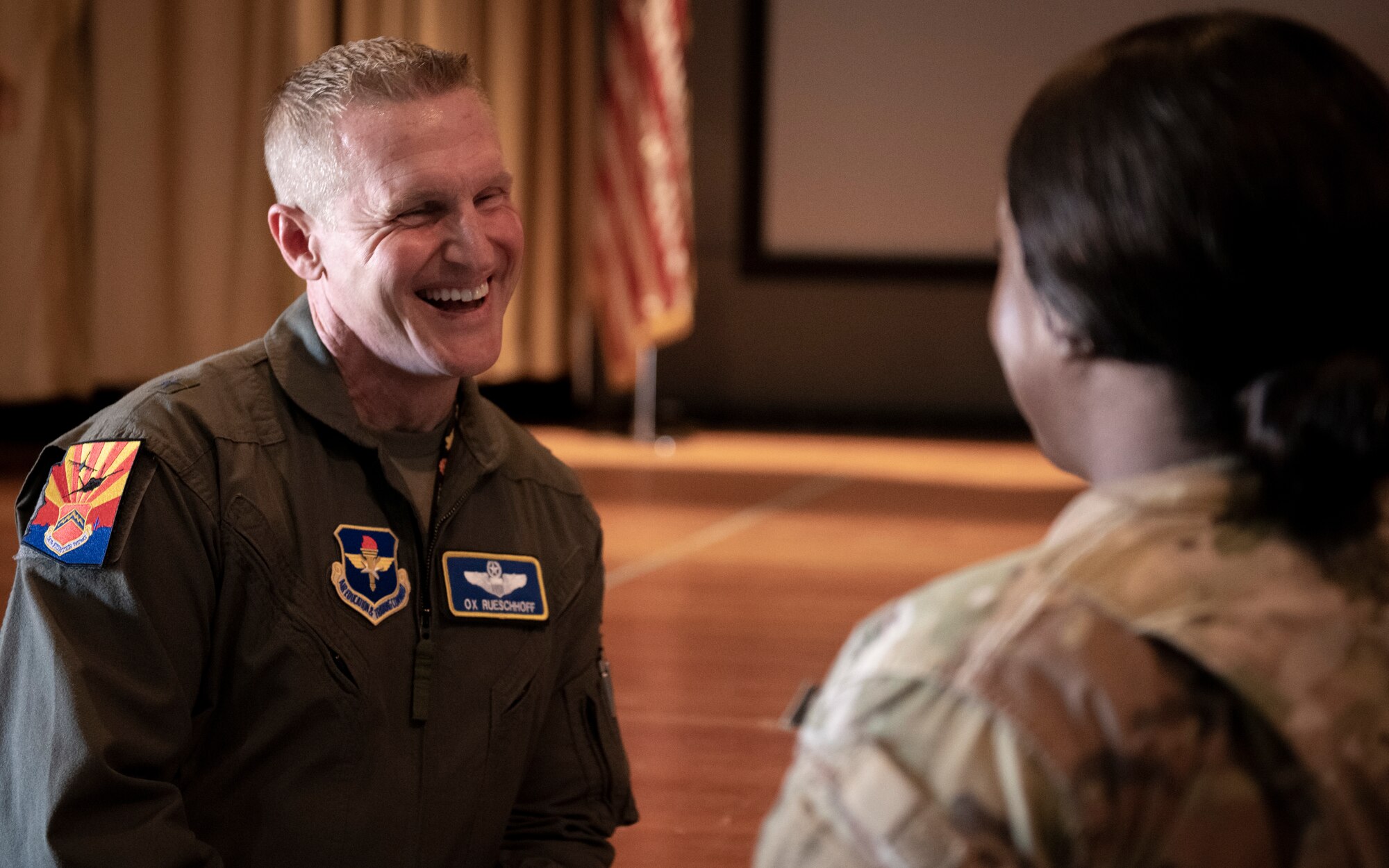 U.S. Air Force Brig. Gen. Jason M. Rueschhoff, 56th Fighter Wing commander, speaks with an Airman of the 56th FW, August 5, 2022, at Luke Air Force Base, Arizona.