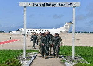 Military members walk away from an aircraft