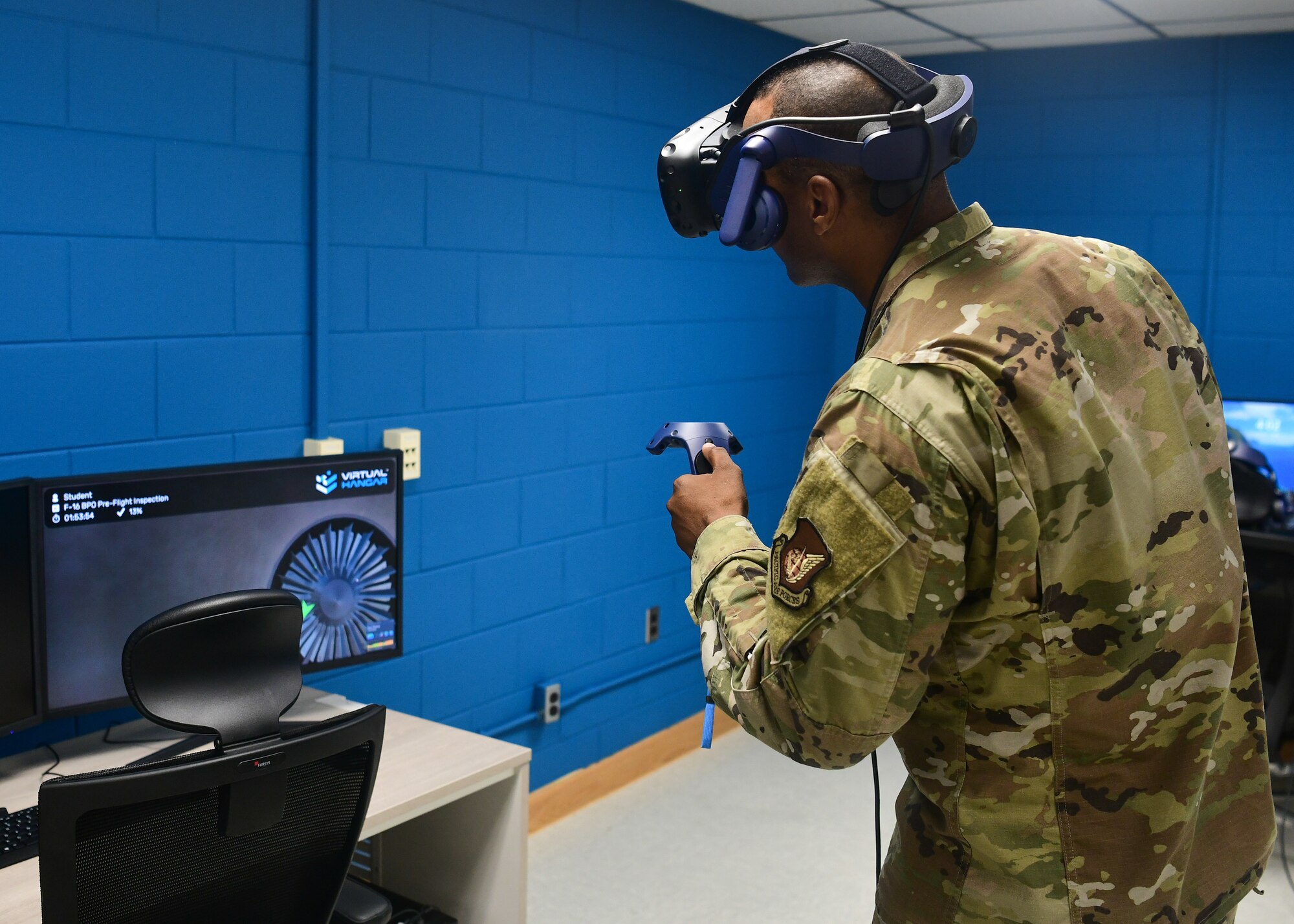A military member works inside virtual reality on a military aircraft.