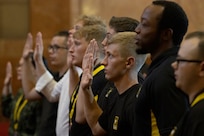 Future Soldiers recite an oath of enlistment during a Future Soldier Recognition Event at the Indiana War Memorial in Indianapolis Aug. 5, 2022. The event included remarks from influential Army leaders, awards and recognition, and networking opportunities for future Soldiers waiting to ship out to basic combat training. (U.S. Army photo by Mark R. W. Orders-Woempner)