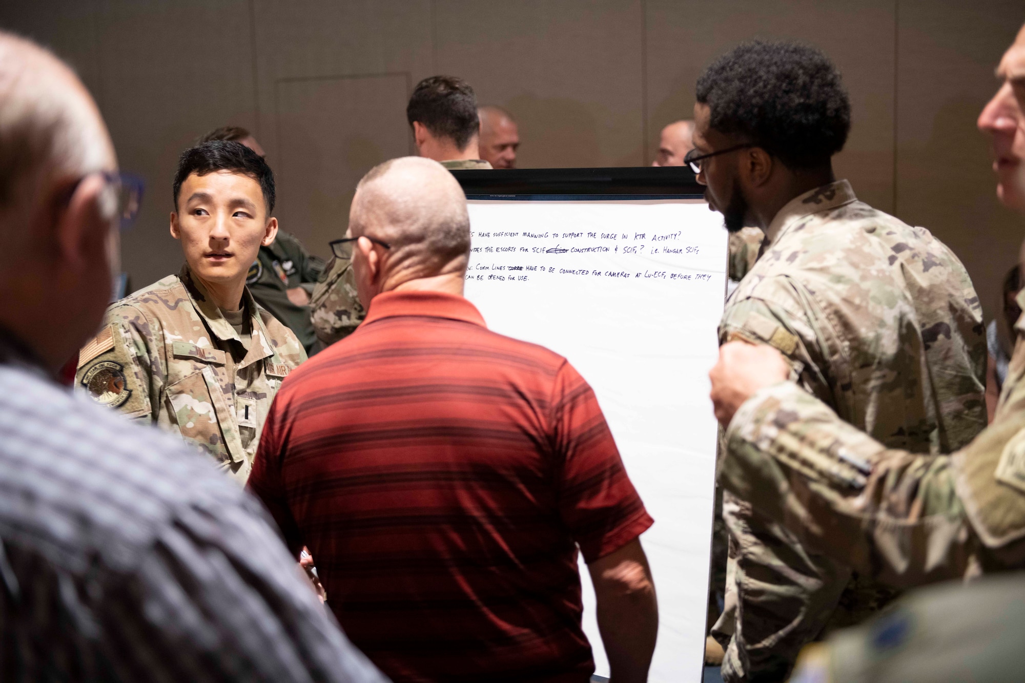 Airmen and civilians brainstorm for ideas.