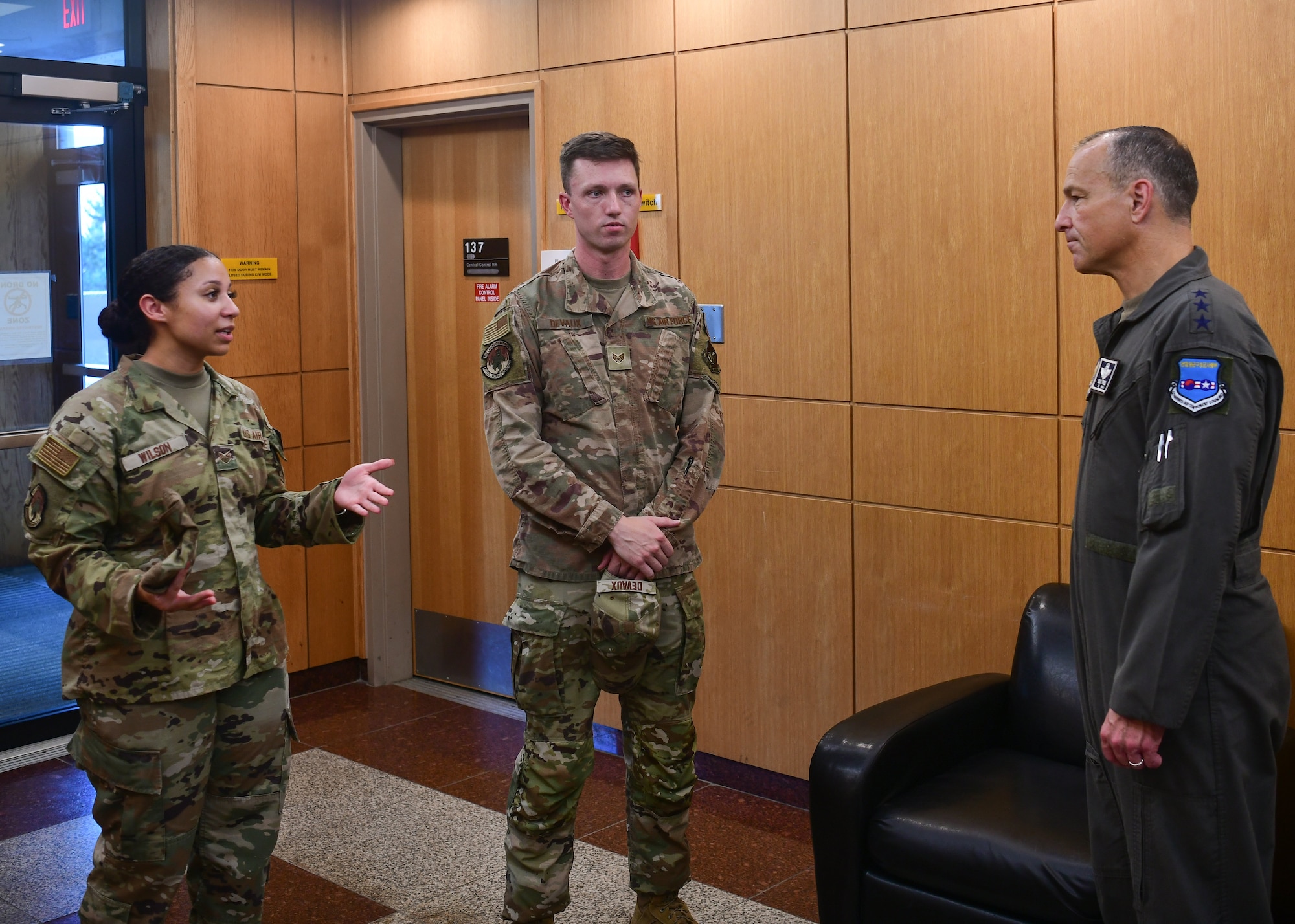 Military members brief each other.