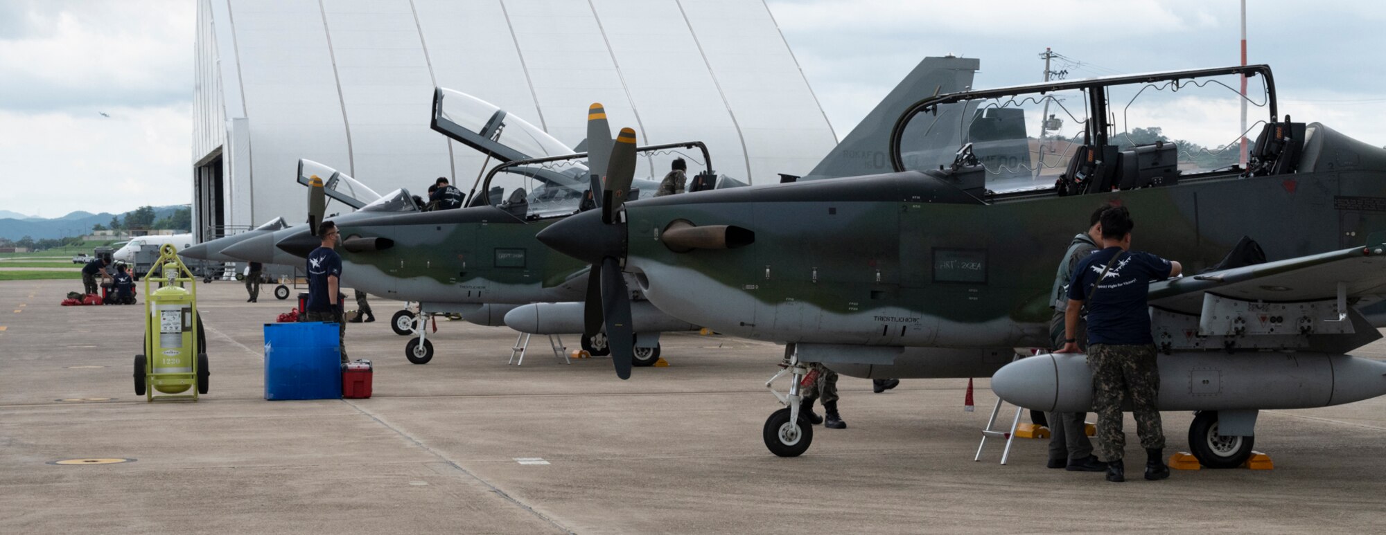 Republic of Korea Air Force FA-50 Golden Eagles and KA-1 Woongbi sit on the flight line for post flight maintenance during Buddy Squadron 22 at Osan Air Base, Republic of Korea, Aug 2, 2022.