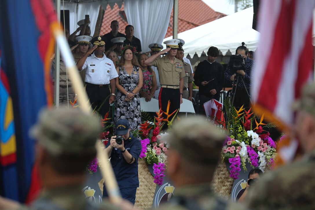 U.S. service members march with the colors to prepare for the National Anthem during the 78th  Liberation Day Parade in Hagåtña, Guam, July 21, 2022.