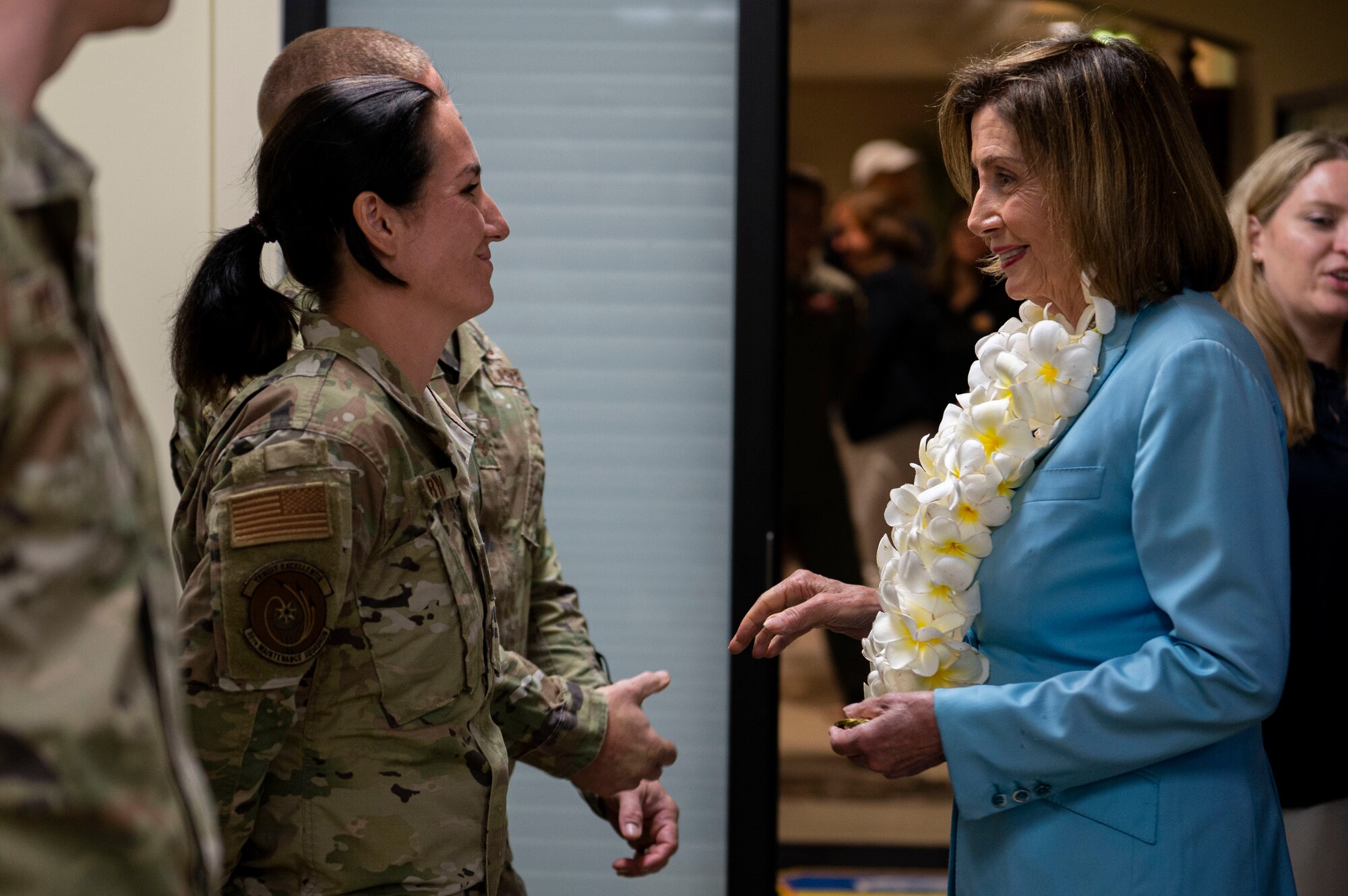 U.S. Air Force Staff Sgt. Samaerah Bryan, 36th Aircraft Maintenance Squadron aircraft structural maintenance shift lead, receives a coin from Speaker of the U.S. House of Representatives Nancy Pelosi at Andersen Air Force Base, Guam, July 31, 2022. Pelosi had the opportunity to recognize outstanding performers during her visit. (U.S. Air Force photo by Staff Sgt. Suzie Plotnikov)