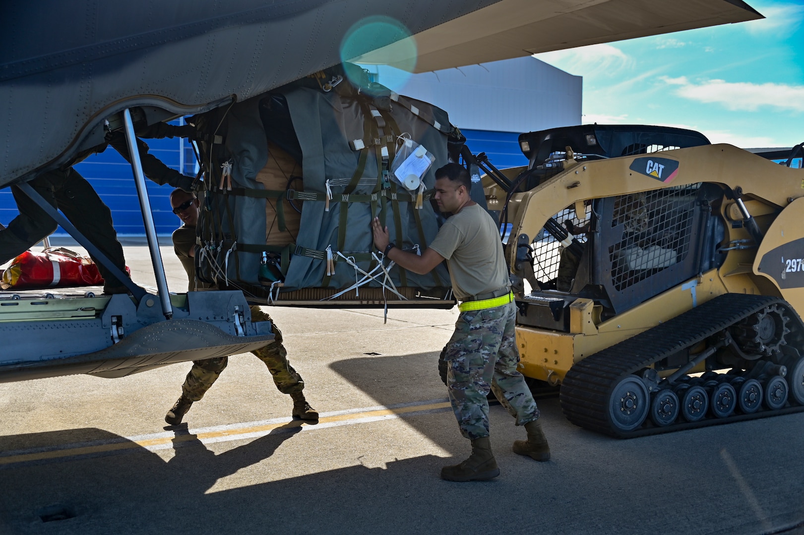 U.S. Air Force HC-130J Combat King II crew chiefs  assigned with the 129th Aircraft Maintenance Squadron, 129th Rescue Wing, California Air National Guard, loads rescue equipment onto the aircraft, August 5, 2022 at Moffett Air National Guard Base, Calif.