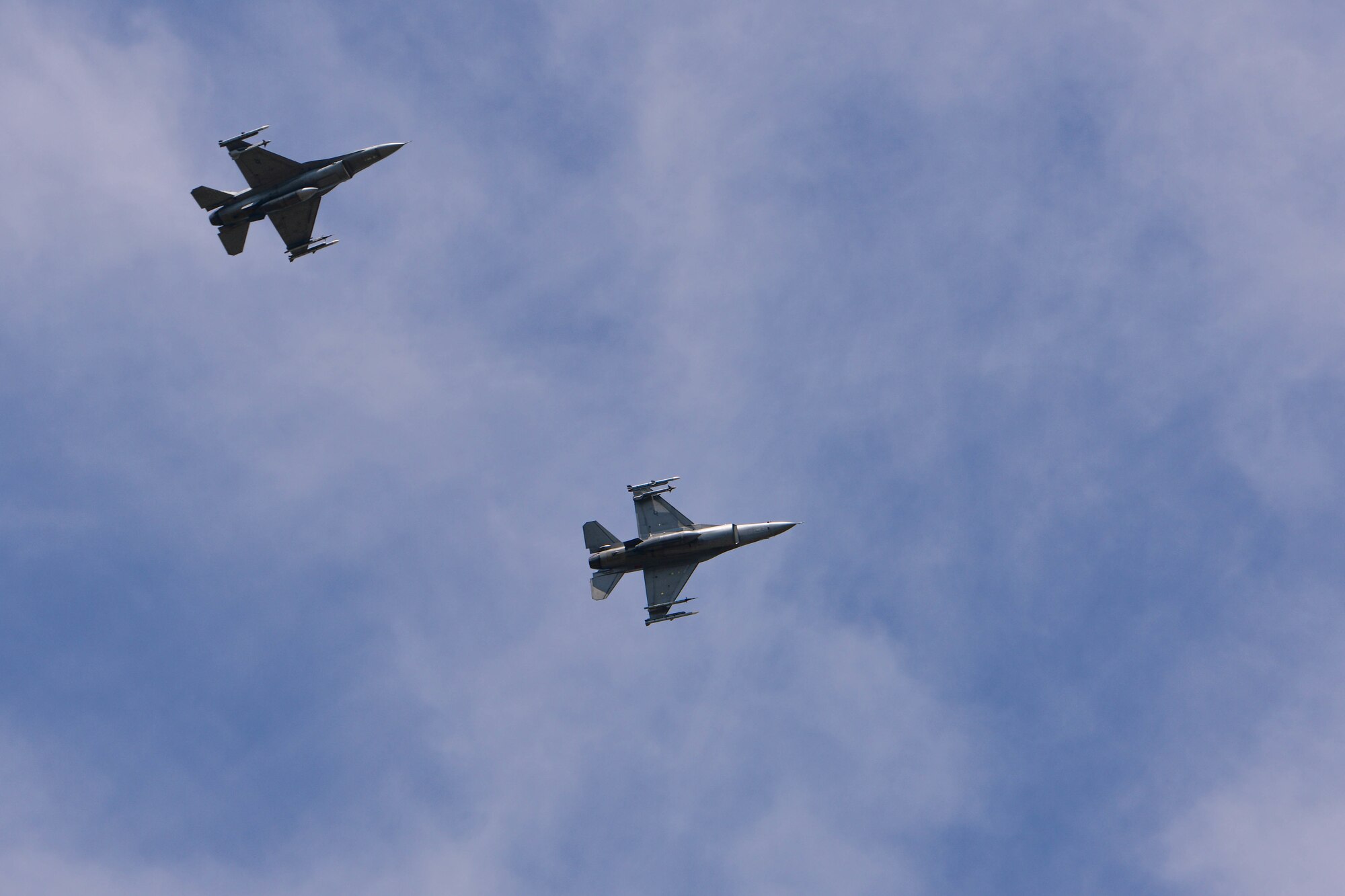 Two U.S. Air Force F-16 Fighting Falcons assigned to the 510th Fighter Squadron fly above Aviano Air Base, Italy, Aug. 8, 2022. The 510th FS is one of two F-16 Fighter Squadrons at Aviano AB that support the base’s many missions, including preparing fighter pilots, controllers, and support personnel to execute U.S. and NATO war plans and contingency operations. (U.S. Air Force photo by Senior Airman Brooke Moeder)