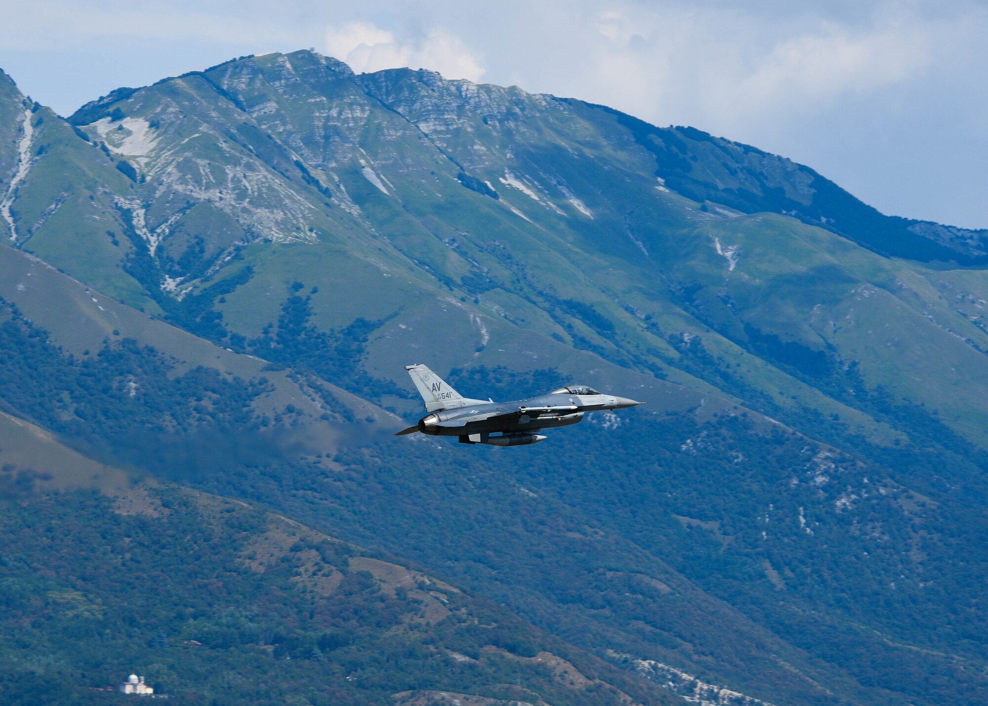 A U.S. Air Force F-16 Fighting Falcon assigned to the 510th Fighter Squadron performs a low pass at Aviano Air Base, Italy, Aug. 8, 2022. A low pass maneuver involves diving low and making another pass around the flight zone instead of touching down and landing on the flightline. (U.S. Air Force photo by Senior Airman Brooke Moeder)