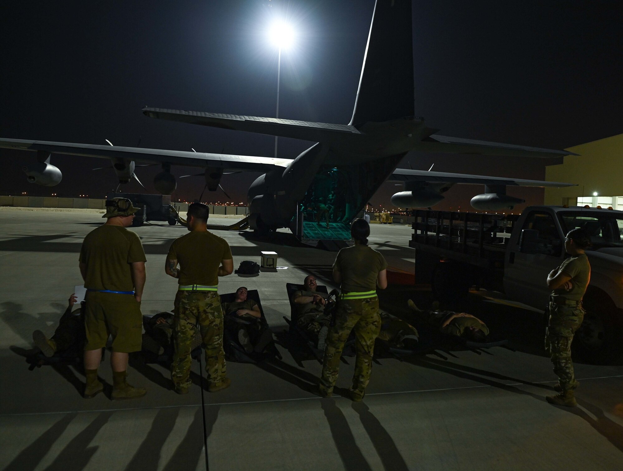 Patients with simulated wounds await transport aboard an MC-130J Commando II aircraft during an exercise Aug 4, 2022 at Al Udeid Airbase, Qatar. The exercise allowed multiple organizations including medical, maintenance and aircrew to train together during casualty care and transportation. (U.S. Air National Guard photo by Master Sgt. Michael J. Kelly)
