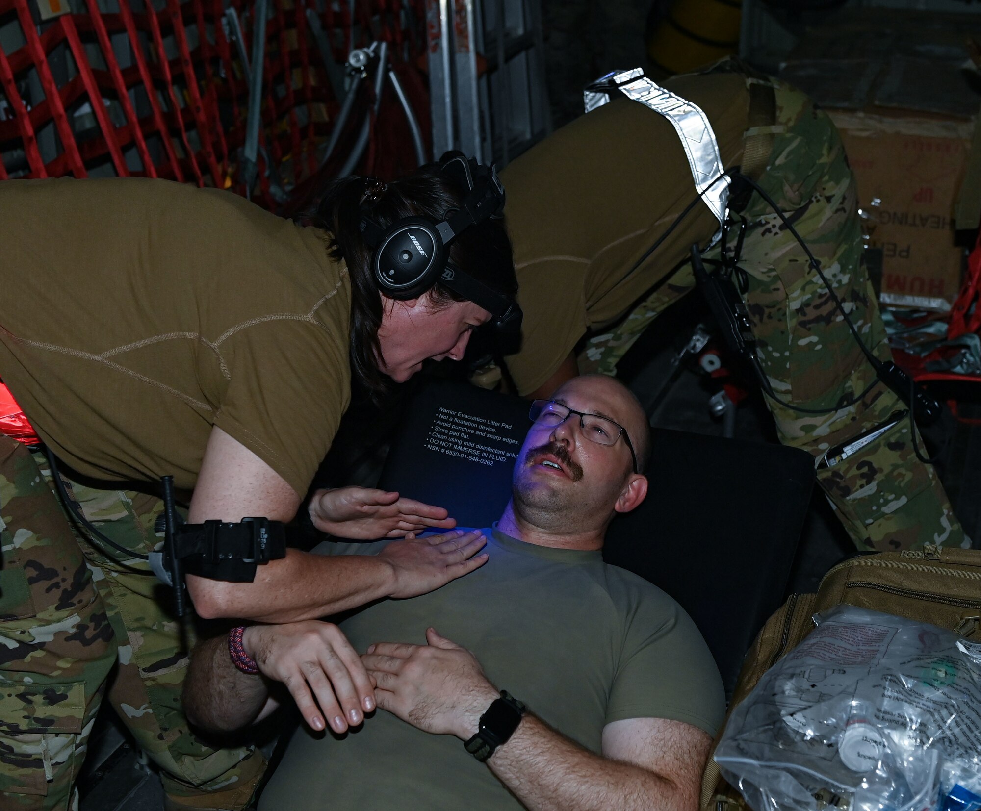 U.S. Air Force Capt. Beth Weaver (left), a 379th Expeditionary Air Evacuation Squadron nurse, tends to a patient during an exercise Aug 4, 2022 at Al Udeid Airbase, Qatar. The medical staff tended to a variety of injuries in order to test their readiness to the fullest extent. (U.S. Air National Guard photo by Master Sgt. Michael J. Kelly)