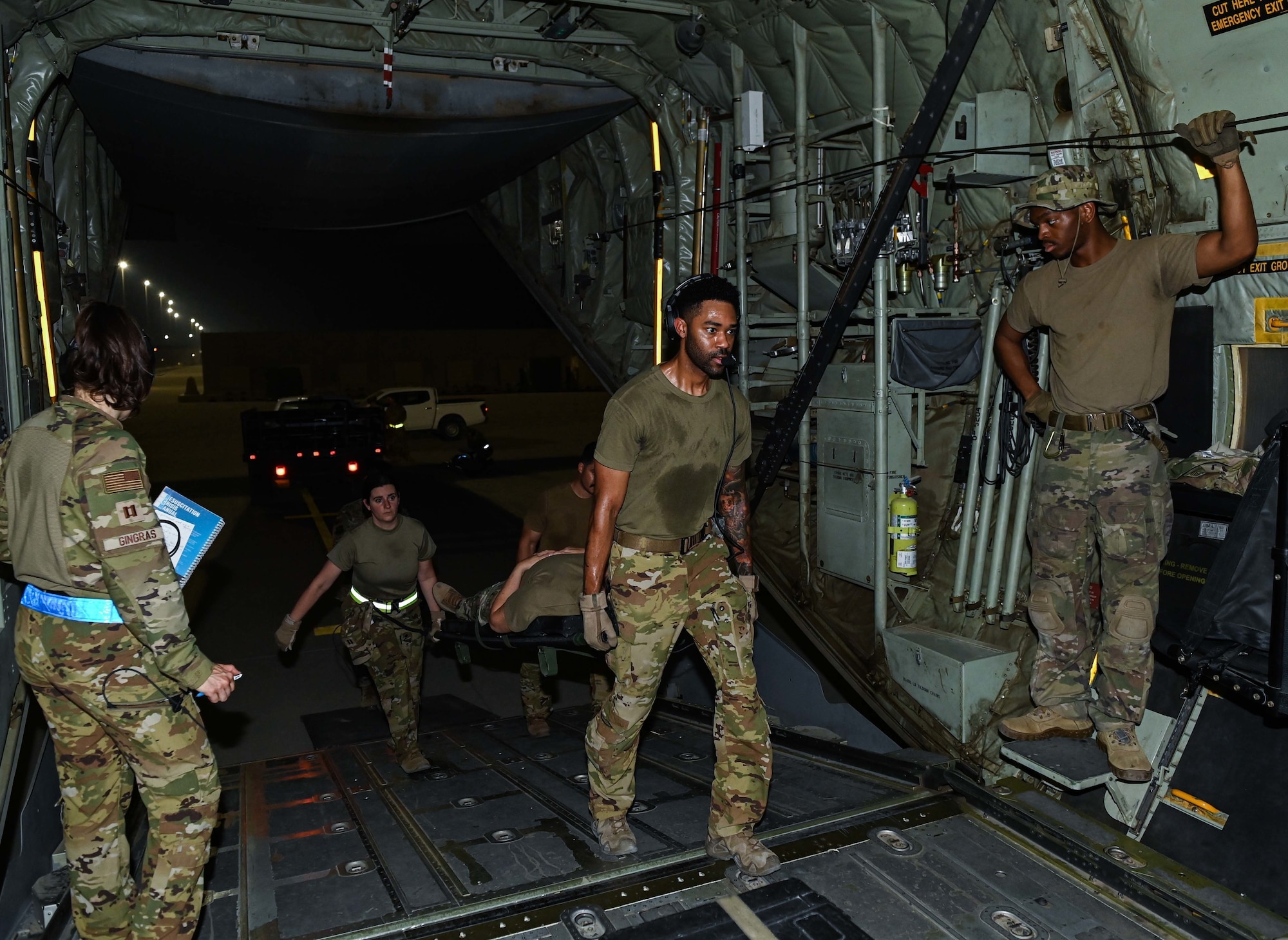Airmen from the 379th Expeditionary Air Evacuation Squadron transport patients on board an MC-130J Commando II during an exercise Aug 4, 2022 at Al Udeid Airbase, Qatar. Casualties stowed away receive swift medical attention from flight nurses. (U.S. Air National Guard photo by Master Sgt. Michael J. Kelly)