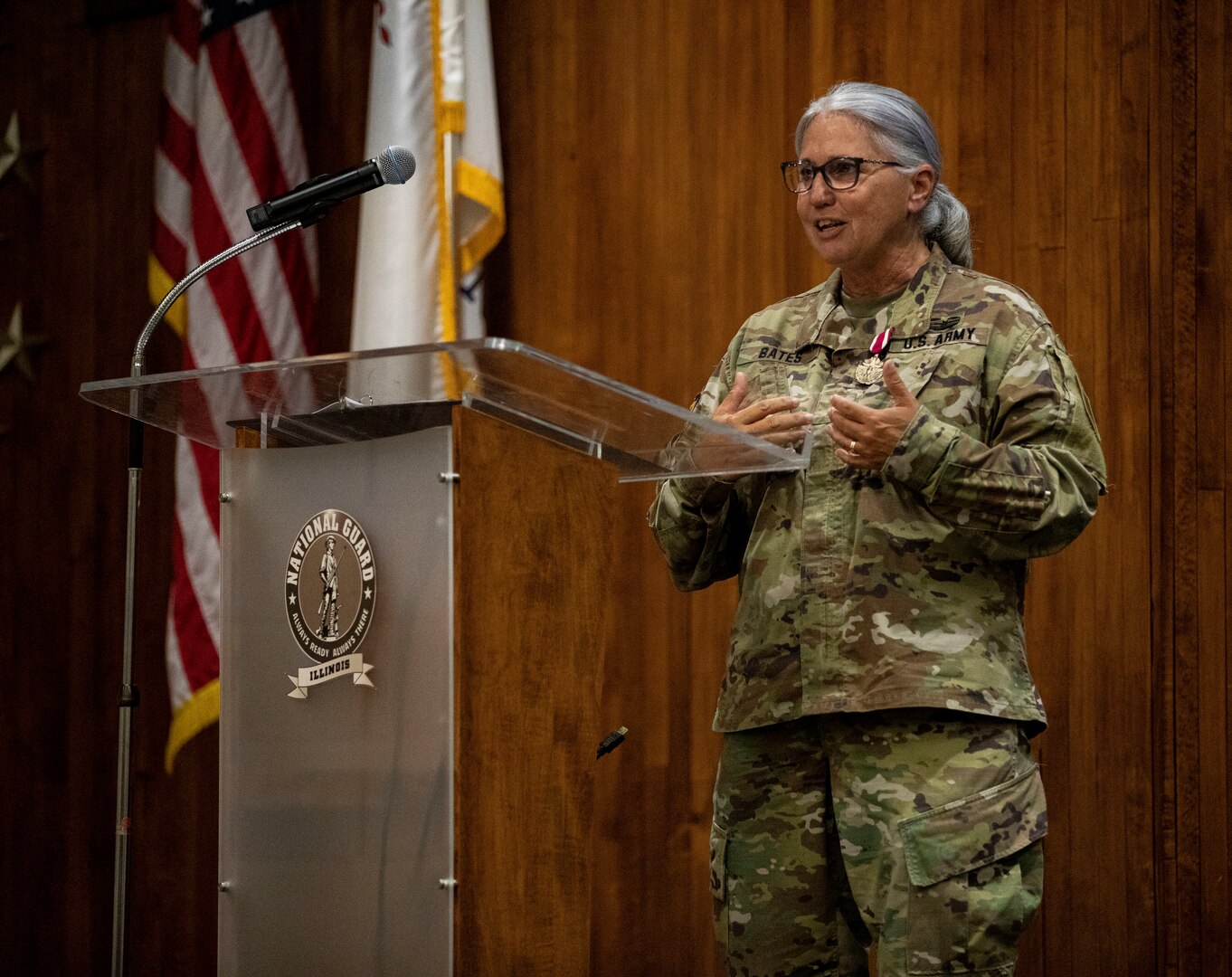 Chief Warrant Officer (4) Peggy Bates gives her remarks during her retirement ceremony at the Illinois Military Academy on Camp Lincoln in Springfield, Il Aug 7. Bates retired after 38 years of military service. She enlisted in the ILARNG in August of 1984 as a Wheeled Vehicle Mechanic with 3637th Maintenance Company in Springfield, IL. CW4 Bates spent the next 22 years as an enlisted Soldier serving in numerous positions to include Parts Clerk, Technical Inspector, Maintenance Control NCO, Operations NCO, and First Sergeant for 3637th Maintenance Company and the 65th Troop Command. She began her Warrant Officer career in 2006 as an Engineer Equipment Maintenance Warrant Officer for B 634th Brigade Support Battalion and converted to a Property Accounting Warrant Officer in 2008. She has served as a Federal Technician for over 37 years. Bates’ dedication to the ILARNG and the technician program enhanced the logistics community within the entire state. (U.S. Army photo by Illinois Army National Guard Sgt. Trenton Fouche)