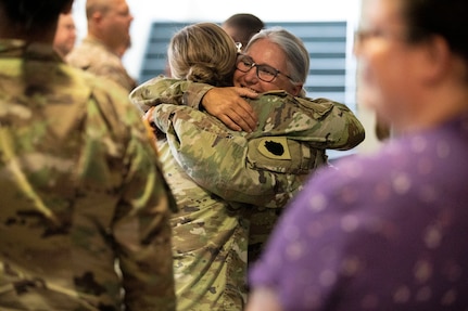 Chief Warrant Officer (4) Peggy Bates hugs friends after her retirement ceremony at the Illinois Military Academy on Camp Lincoln in Springfield, Il Aug 7. Bates retired after 38 years of military service. She enlisted in the ILARNG in August of 1984 as a Wheeled Vehicle Mechanic with 3637th Maintenance Company in Springfield, IL. CW4 Bates spent the next 22 years as an enlisted Soldier serving in numerous positions to include Parts Clerk, Technical Inspector, Maintenance Control NCO, Operations NCO, and First Sergeant for 3637th Maintenance Company and the 65th Troop Command. She began her Warrant Officer career in 2006 as an Engineer Equipment Maintenance Warrant Officer for B 634th Brigade Support Battalion and converted to a Property Accounting Warrant Officer in 2008. She has served as a Federal Technician for over 37 years. Bates’ dedication to the ILARNG and the technician program enhanced the logistics community within the entire state. (U.S. Army photo by Illinois Army National Guard Sgt. Trenton Fouche)