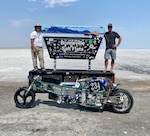 Jaron Tyner with his teammate and cousin Tyrell Marlow and their custom-built motorcycle, the Coconut Express