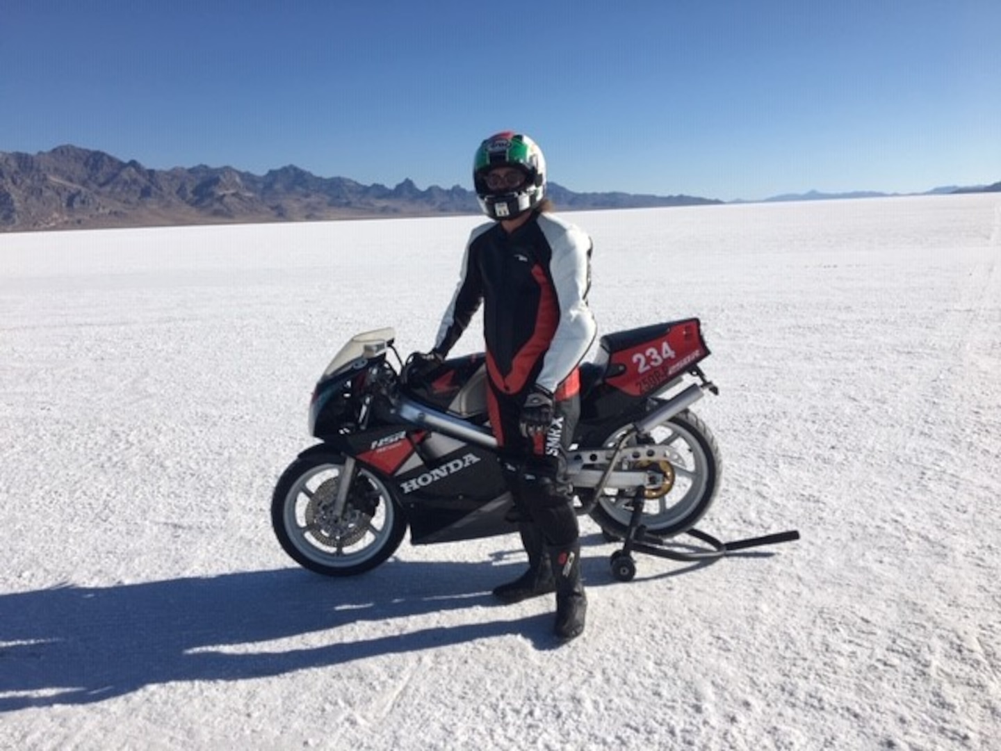 Jaron Tyner stands with his first personal record-breaking motorcycle