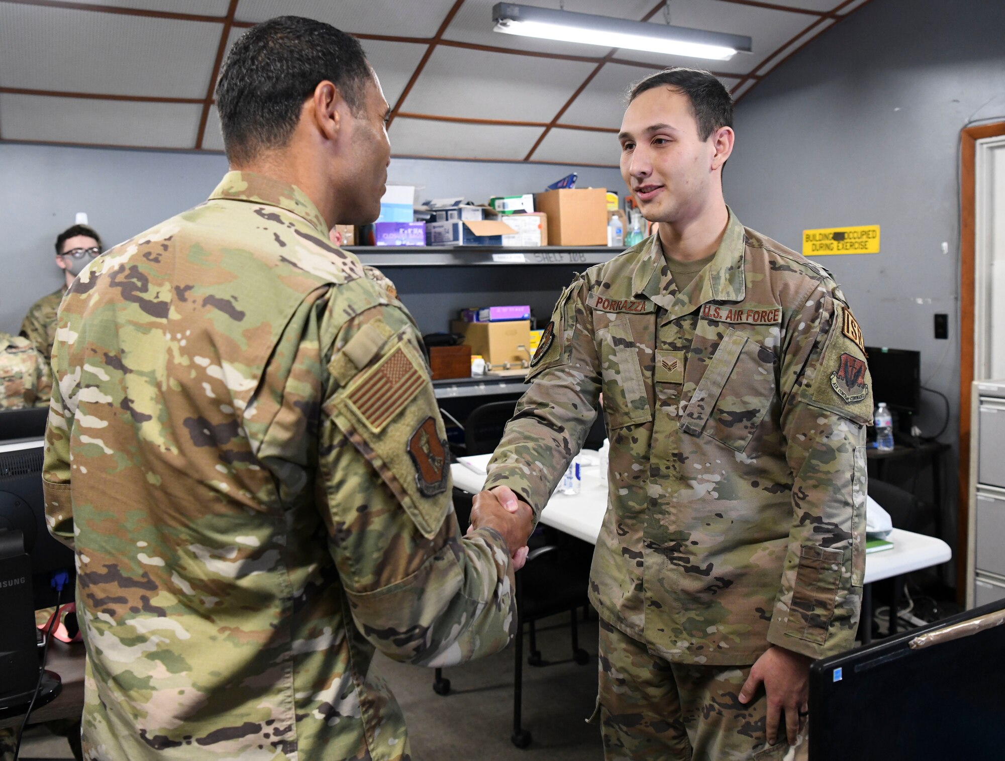 Col. Curry shakes hands with an airman from the 4th Reconnaissance Squadron.