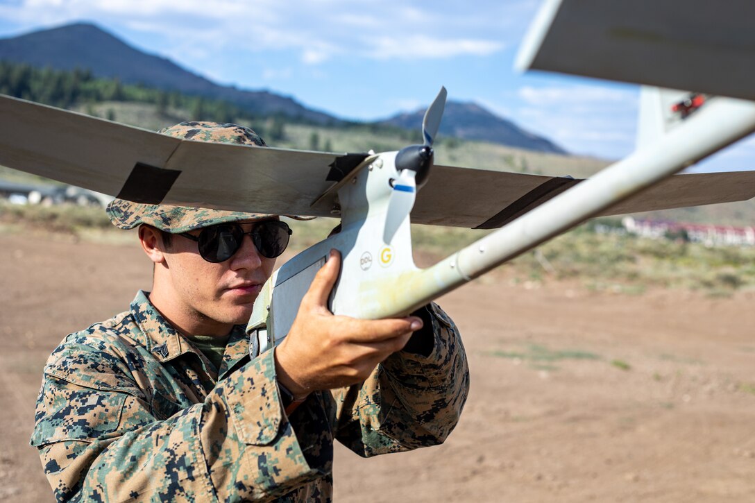 Cpl. Cole Millard, a Raven-B RQ-11 operator and intelligence specialist with H&S Company, 1st Battalion, 24th Marine Regiment, 4th Marine Division, Marine Forces Reserve, sets up and prepares to launch a Raven-B RQ-11 drone at Marine Corps Mountain Warfare Training Center, Bridgeport, Calif., July 27, 2022, for Mountain Training Exercise 4-22. MTX 4-22 allowed reserve Marines to participate in mountain warfare operations for realistic combat training to facilitate increased readiness for the Marine Forces Reserve. (U.S. Marine Corps photo by Cpl. Jonathan L. Gonzalez)