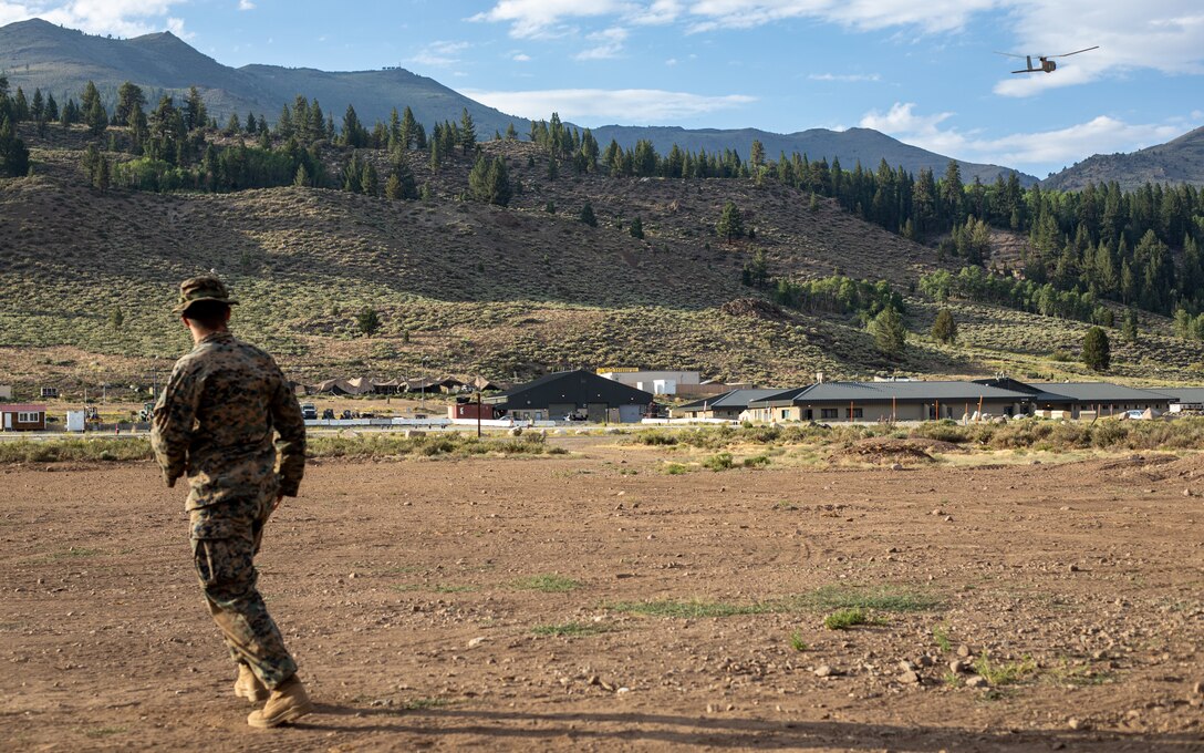 Cpl. Cole Millard, a Raven-B RQ-11 operator and intelligence specialist with H&S Company, 1st Battalion, 24th Marine Regiment, 4th Marine Division, Marine Forces Reserve, launches a Raven-B RQ-11 drone into the sky at Marine Corps Mountain Warfare Training Center, Bridgeport, Calif., July 27, 2022, for Mountain Training Exercise 4-22. MTX 4-22 allowed reserve Marines to participate in mountain warfare operations for realistic combat training to facilitate increased readiness for the Marine Forces Reserve. (U.S. Marine Corps photo by Cpl. Jonathan L. Gonzalez)