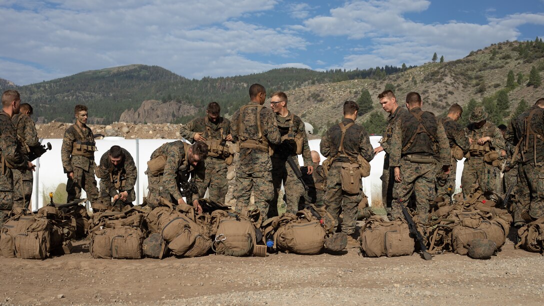 U.S. Marines with 1st Battalion, 24th Marine Regiment, 4th Marine Division, Marine Forces Reserve, conduct gear inspections after finishing a hike for Mountain Training Exercise 4-22 at Marine Corps Mountain Warfare Training Center, Bridgeport, Calif., July 28, 2022. MTX 4-22 offers a unique training experience for reserve Marines to prepare and develop an understanding of traversing a mountainous environment as they maintain their readiness. (U.S. Marine Corps photo by Cpl. Jonathan L. Gonzalez)
